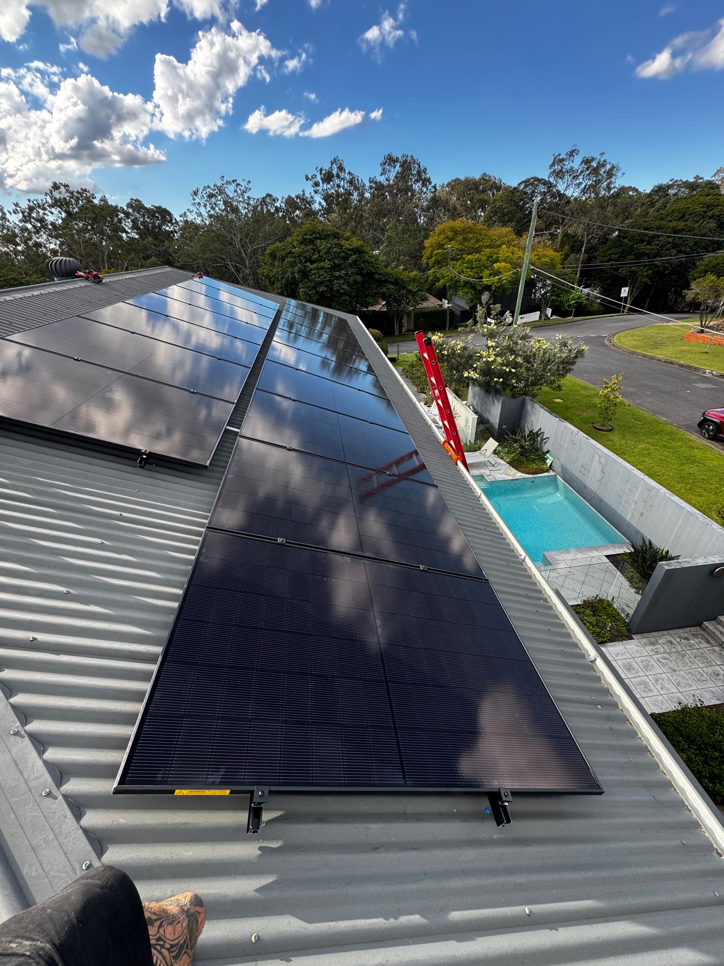 Licensed installers fitting solar panels on a Queensland home