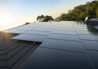 Residential rooftop solar panels at sunset