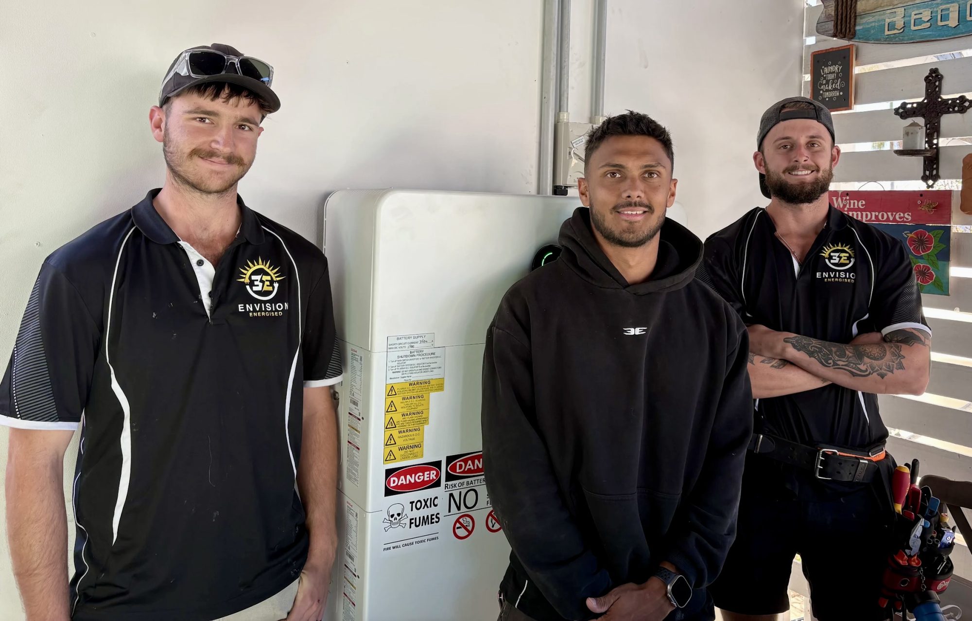 Envision Energised electricians beside a completed home battery installation